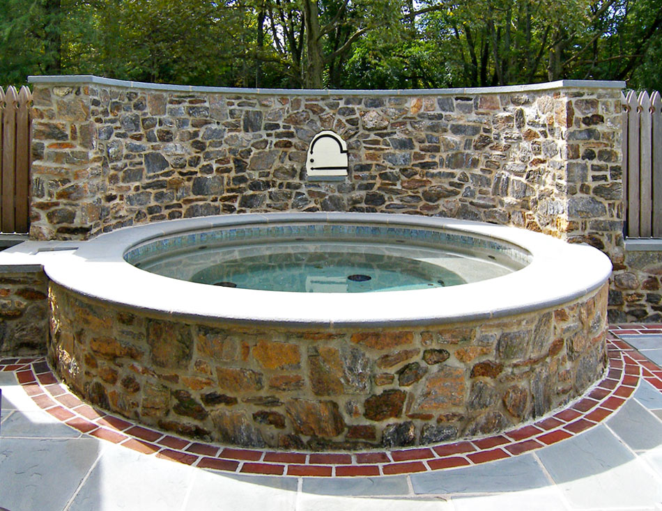 View of stone pool wall from the road